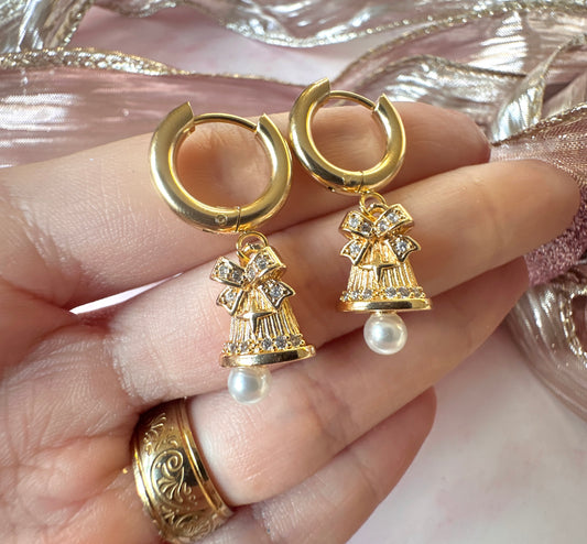 Gold Pearl Jingle Bell Huggie hoop earrings.