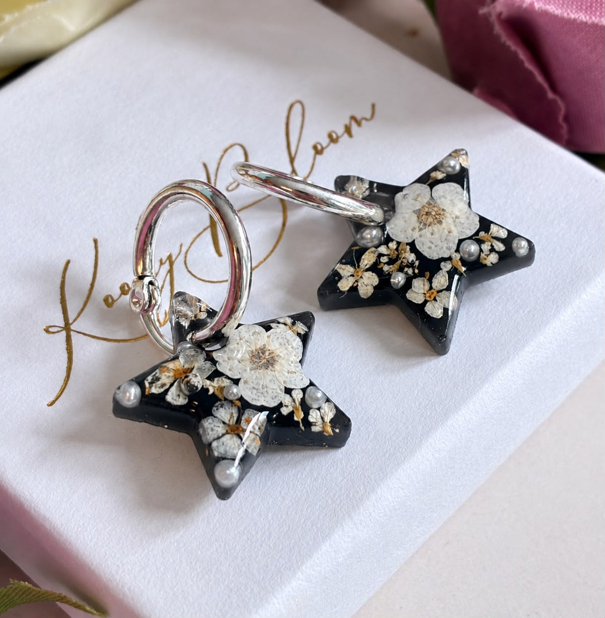 Midnight Pearl Star bloom hoop earrings.