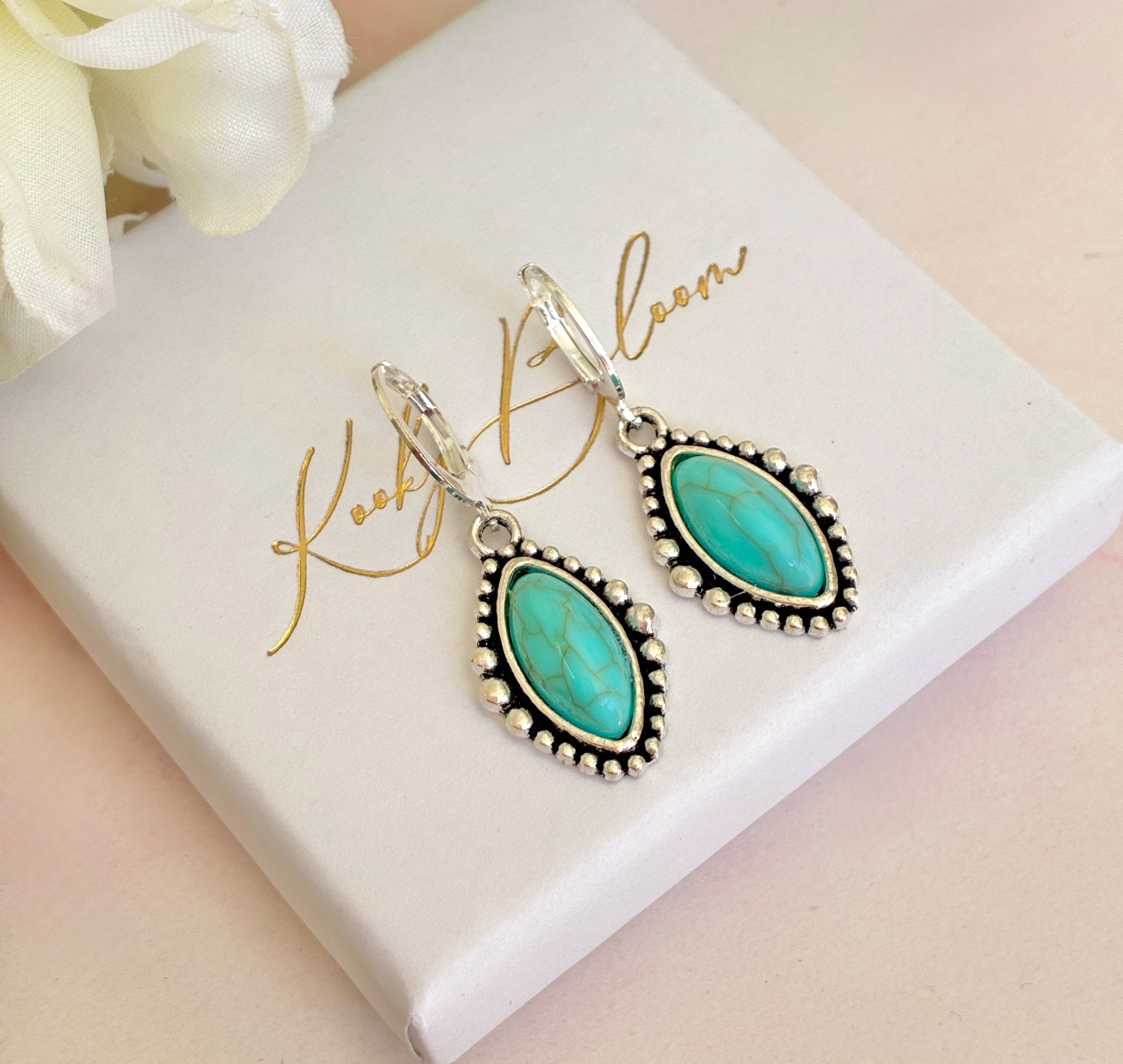 Silver Turquoise stone horse eye huggie earrings.