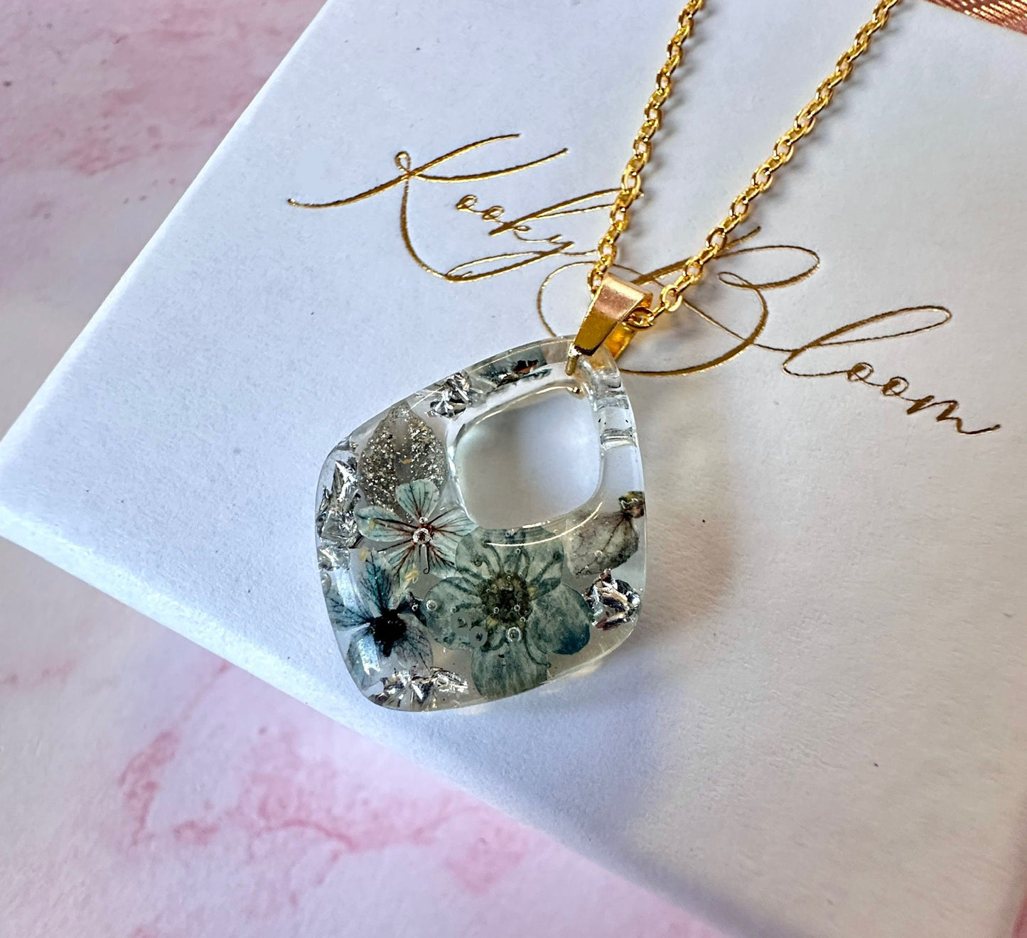 Gold Frosted floral grey diamond necklace.