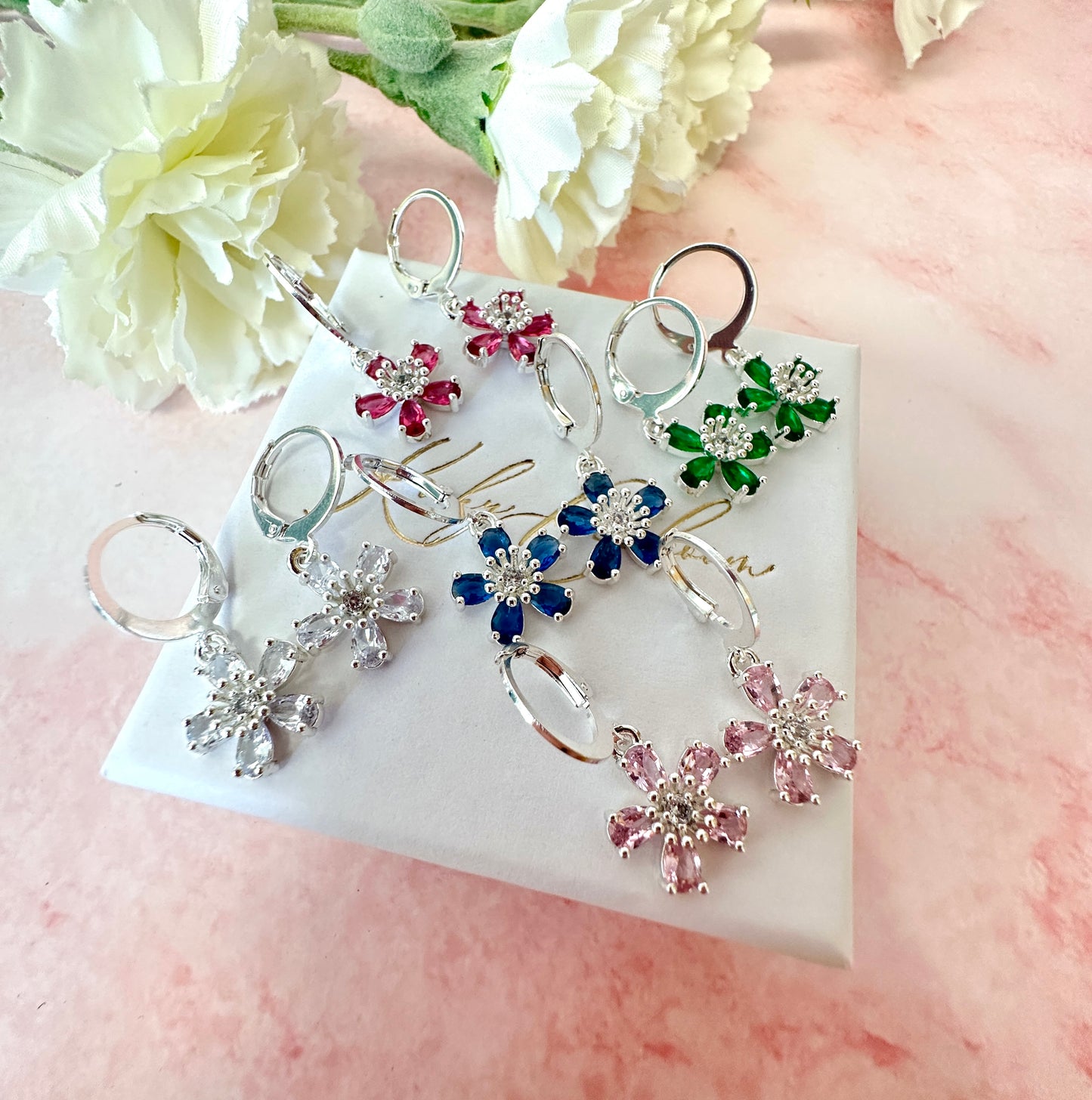 Silver colourful CZ flower huggie earrings .