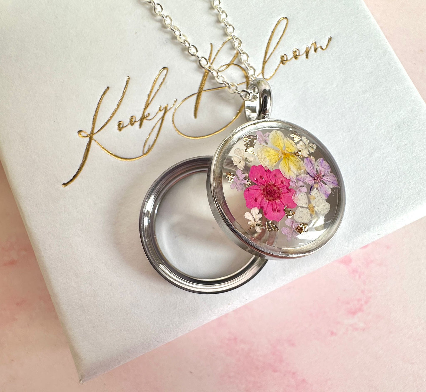 Silver Real flower capsule locket necklace.