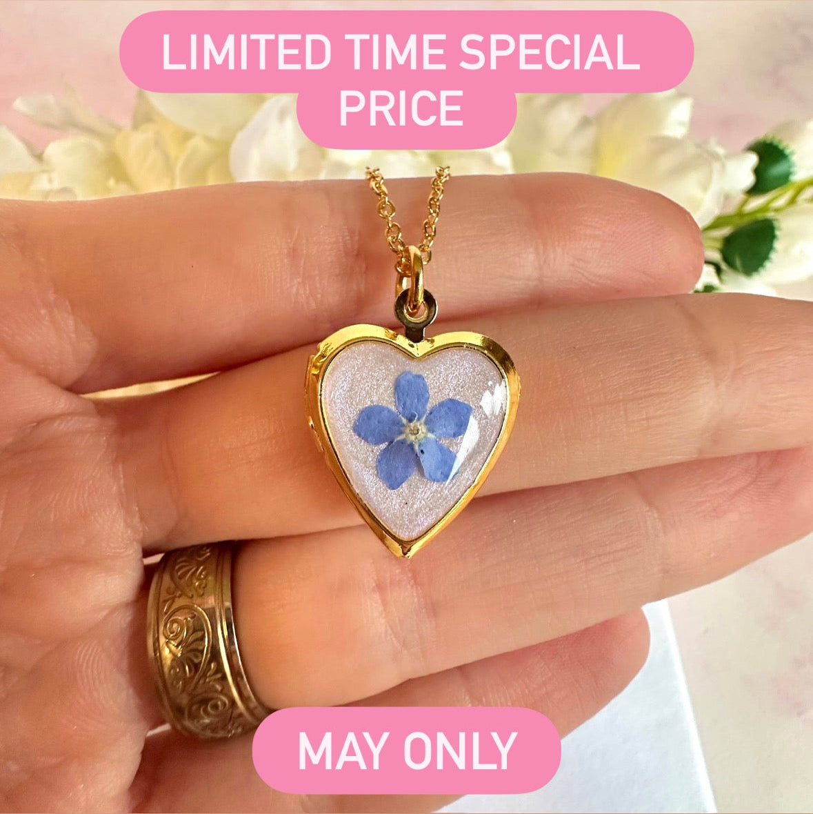 Gold forget me not flower heart locket necklace.