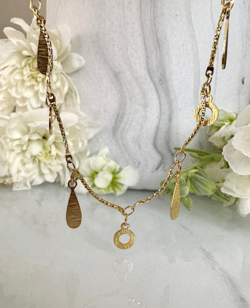 Gold tear drop circle necklace.