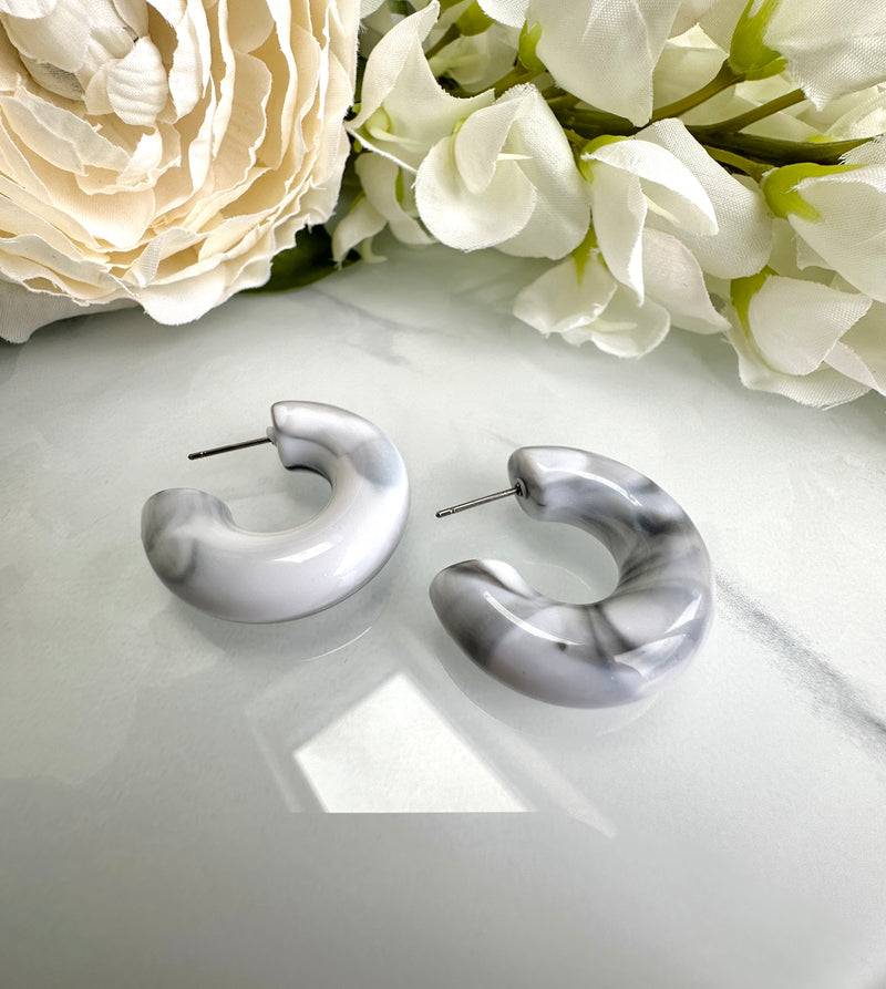 Chunky white marble effect hoop earrings.